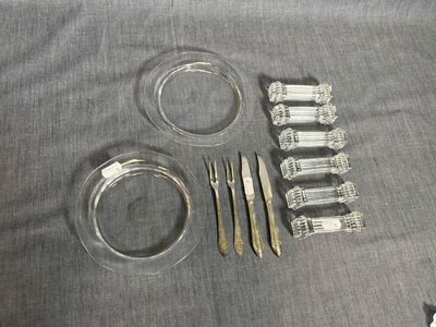 a lot of silverware sitting on a table