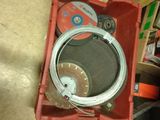 a red box with a wire in it on the floor