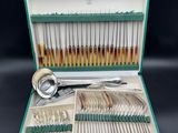 a green case with silverware in it on a table