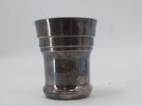 a silver cup that is sitting on a table