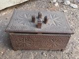 a small wooden box that is sitting on the ground