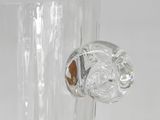 a clear glass vase with a dog head on it