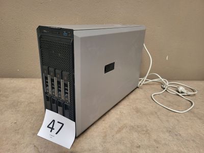 a small computer on a table with a price tag attached to it