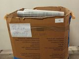 a cardboard box on a pallet with a pen in it