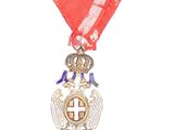 an image of a medal with a cross and wings on it