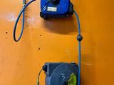 a blue hose attached to a wall next to a yellow wall