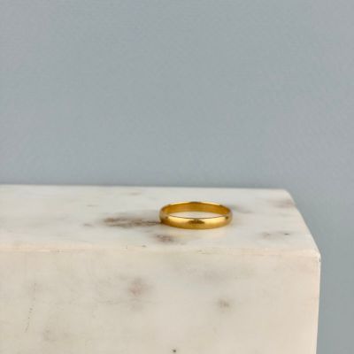 une bague en or posée sur un bloc de marbre