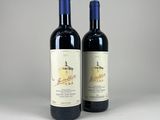 two bottles of wine sitting next to each other on a table