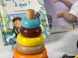 a stack of wooden toys and a book on a table