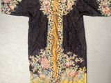 a black and yellow embroidered jacket with flowers on it