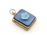 l'image d'une petite fleur bleue dans un nœud doré