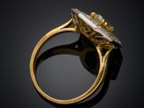 a gold ring with an oval stone surrounded by a diamond