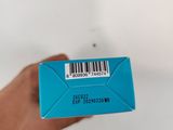 a person holding a blue box with a barcode on it