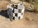 a fire pit made out of cinder blocks in the dirt
