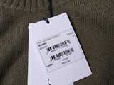 a close up of a sweater with a price tag attached to it