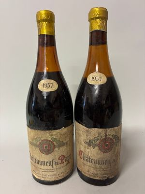 two bottles of wine sitting next to each other on a table