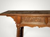 an old wooden table with a carved top on a white background
