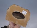 a person holding up a cardboard box with a hole in it