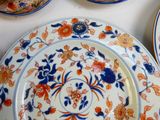 many plates with different designs on them on a table
