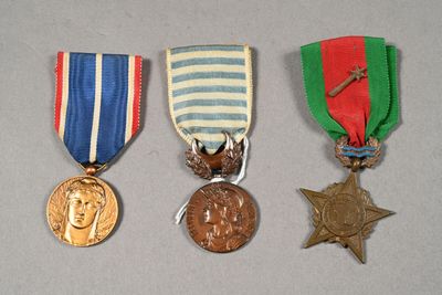 three medals and a medal sitting on top of a table