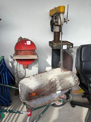 a wheelbarrow in the middle of a room with a fire hydrant in the background