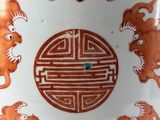 a white vase with a design of animals on it