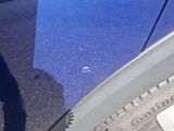 a blue car parked on the side of the road