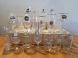 bottles and glasses are lined up on a wooden box on a table