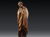 a carved wooden statue of a woman holding a child