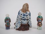 three figurines of a woman and two children