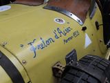 a close up of a yellow car with a sign on it