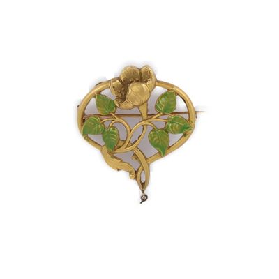 un gros plan d'une broche en or ornée d'une fleur