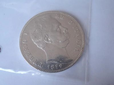 an image of a silver coin sitting on top of a white surface