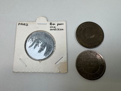 deux pièces et une pièce posées sur une surface blanche