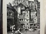 un vieux livre sur lequel figure l'image d'une ville