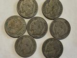 six different types of coins on a piece of paper on a table