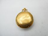 an image of a gold pocket watch sitting on top of a white table