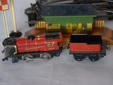 a toy train that is sitting next to other toy trains