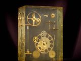 a glass box with gears inside of it on a table