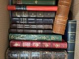 a box full of old books sitting on top of each other
