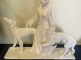 a figurine of a woman and a dog on a table