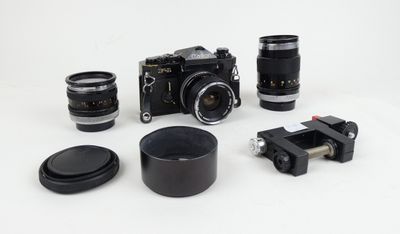 a lot of different cameras and lenses on a white surface