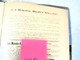 a pink post it on top of an open book