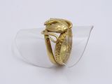 an image of a gold ring with a bird on it