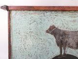 un tableau représentant une vache accroché au mur