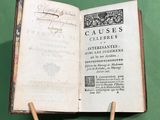 an open book with a wooden stick sticking out of it