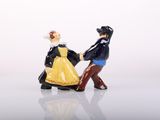 a figurine of a man and a woman holding hands