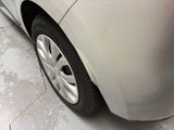 a close up of a car ' s front bumper and tire