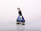 a small figurine of a woman in a blue dress