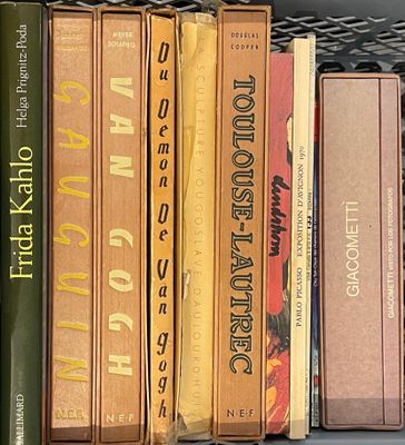 many books that are on a shelf in the room